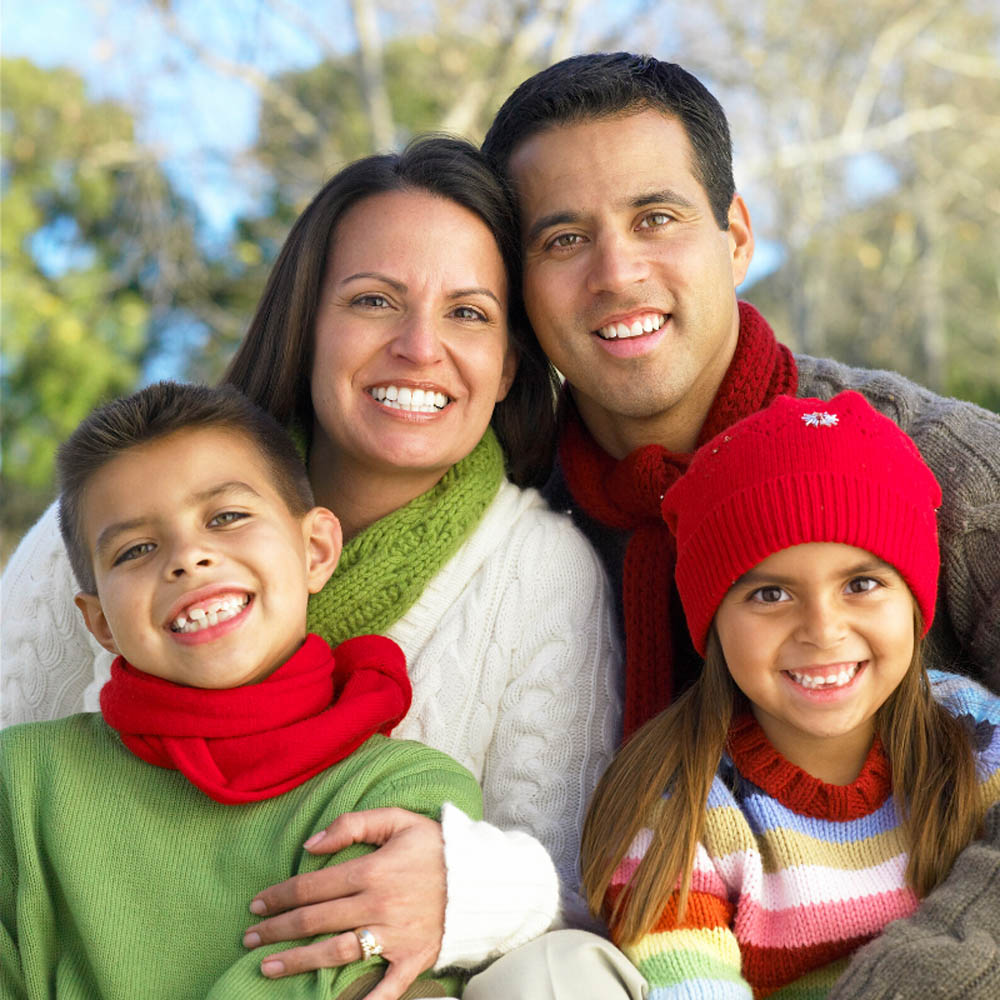 Vaughan family with healthy smile from Dr. Pedvis at Mackenzie Dental Centre