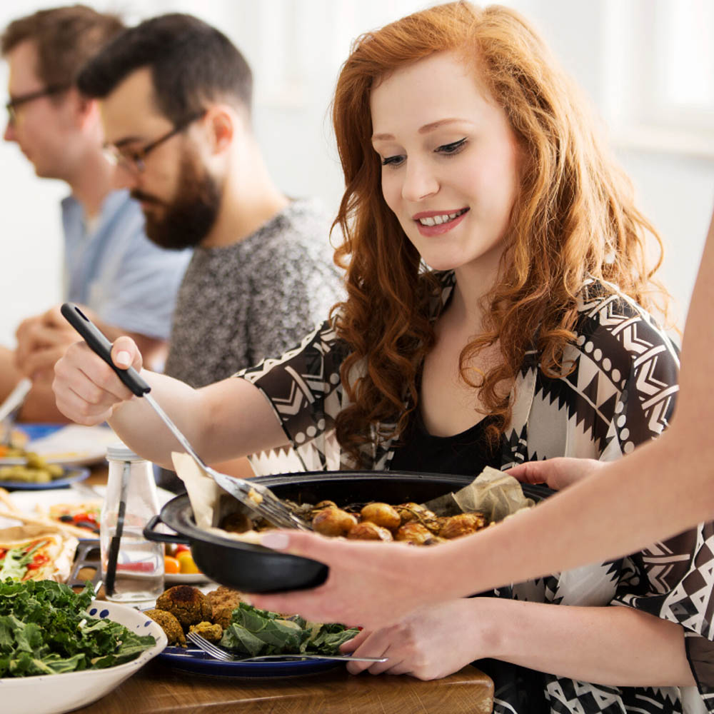 Woman enjoying vegan meal with friends