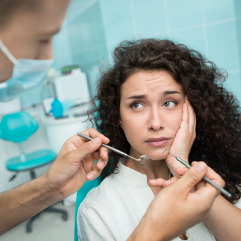 dentist preparing root canal treatment for female patient